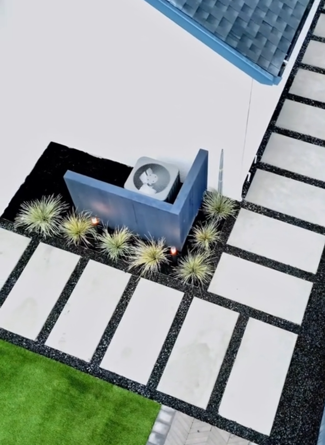 Modern paver steppers with turf and black rock