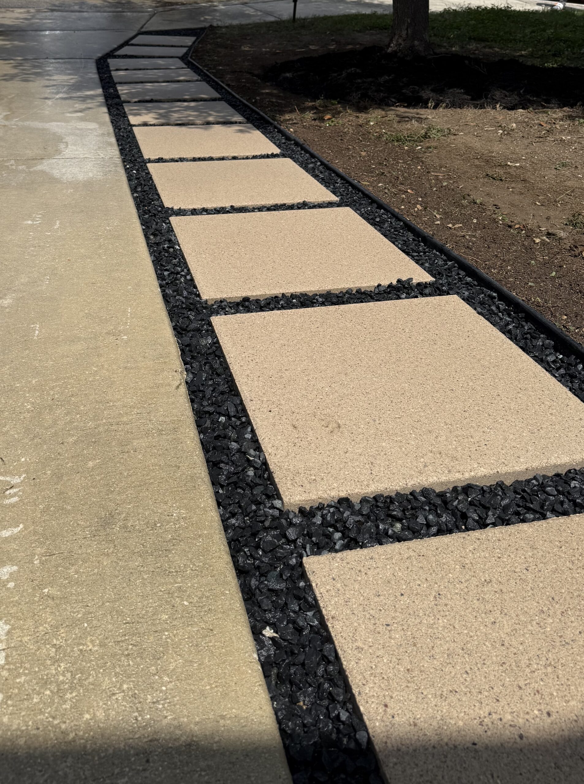 Landscaping in Cordillera Ranch Concrete stepping-stone walkway along a driveway